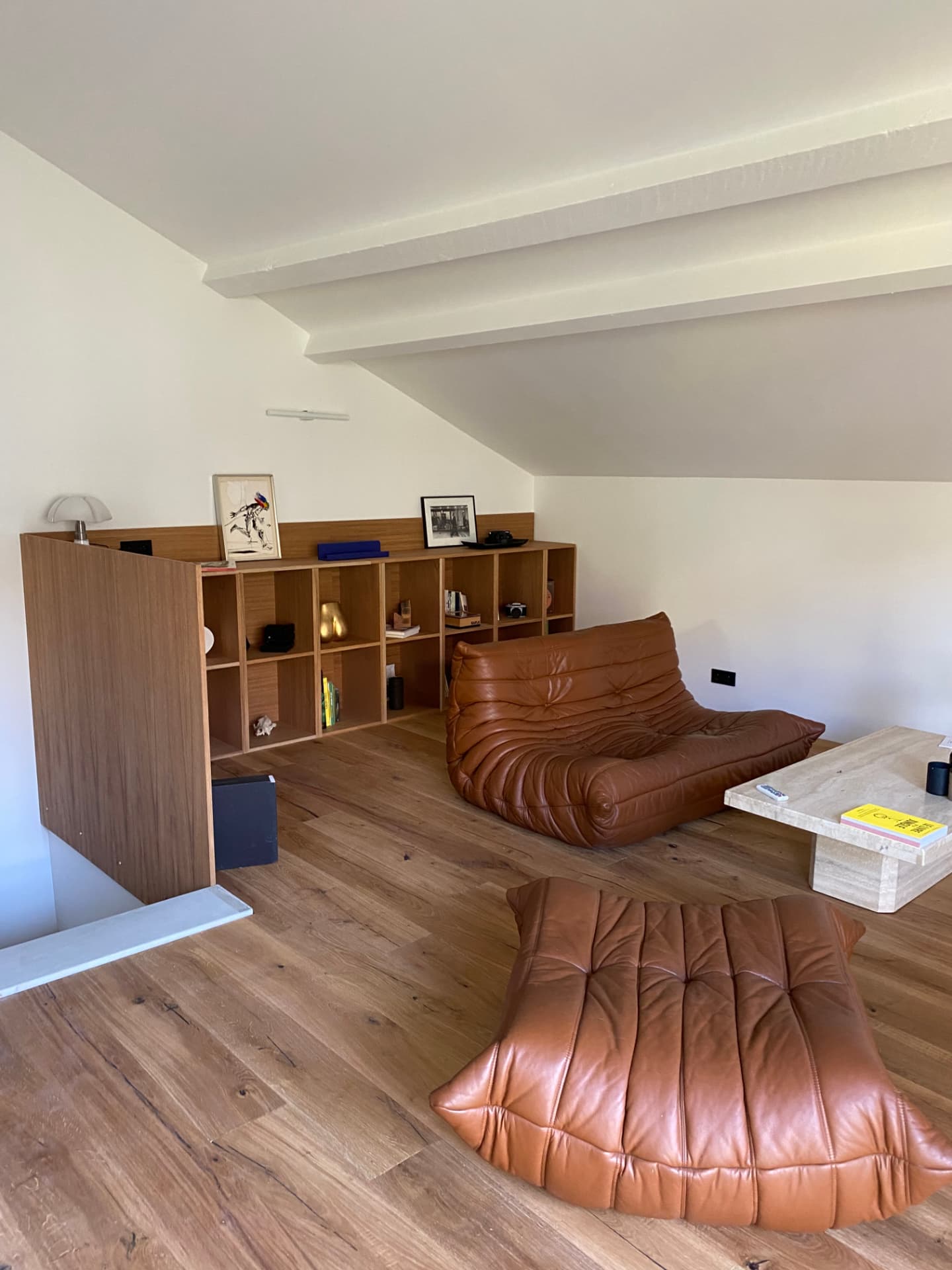 Salon sous combles rénové avec parquet et mobilier sur mesure